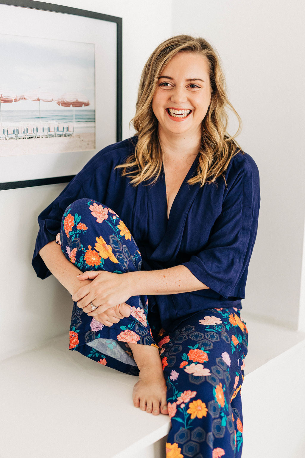 woman laughing in navy adaptive wrap top and colourful adaptive print pants