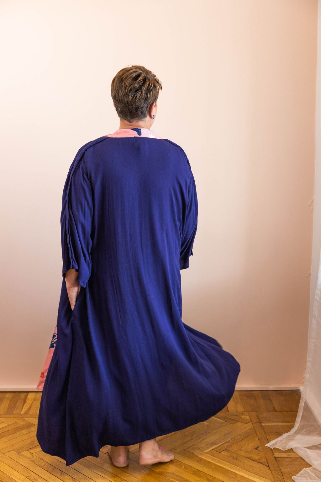 woman twirling in navy adaptive dressing gown