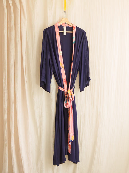limonata navy and pink fiorella print adaptive dressing gown hanging on a coathanger