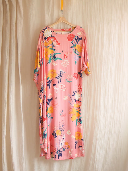 limonata adaptive dolce dress in pink fiorella floral print hanging on a hanger 