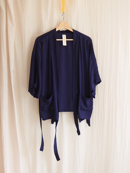 limonata navy grazia adaptive wrap top untied hanging on a coathanger